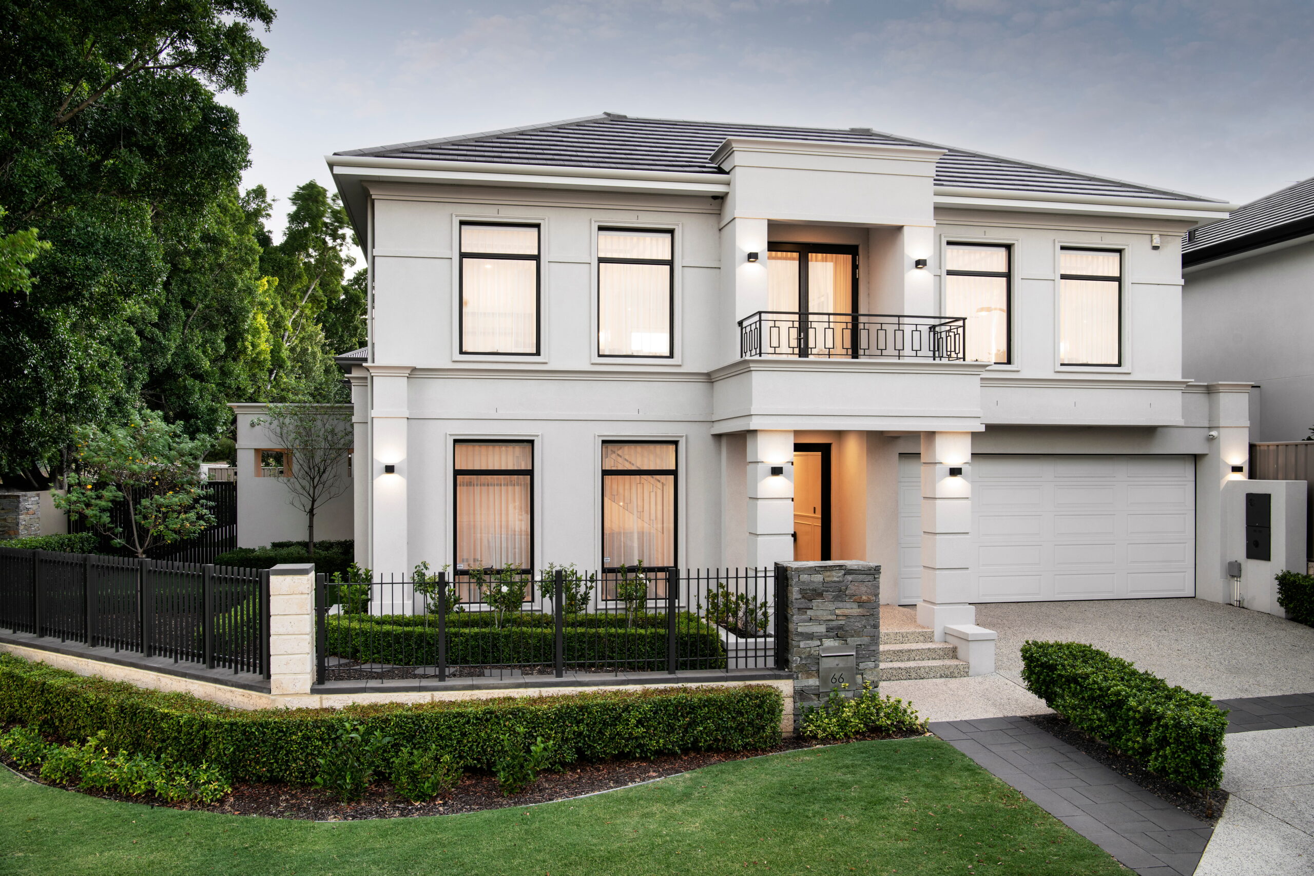 A completed two-storey custom home by Stannard Homes on an established Perth suburban block, featuring a rendered façade, stone detailing and manicured front landscaping